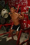 Trainer performing barbell squats