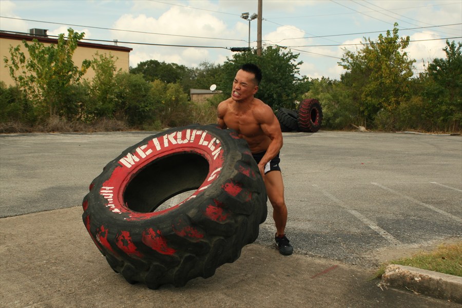 Trainer picking up to flip big tire
