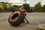 Trainer about to flip big tire